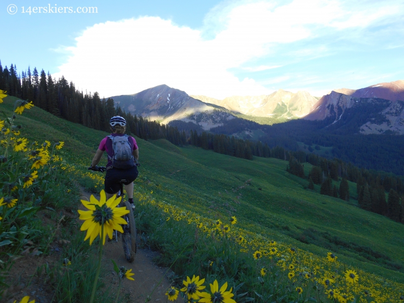 Brittany Konsella riding trail 401 with Rustler's gulch behind.