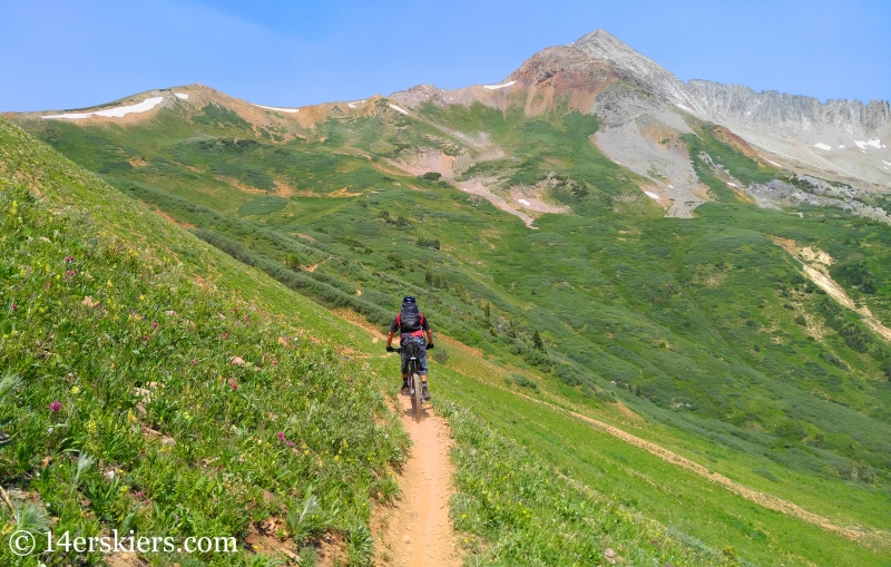 Larry Fontaine mountain biking near Crested Butte with Star Peak in the distance.