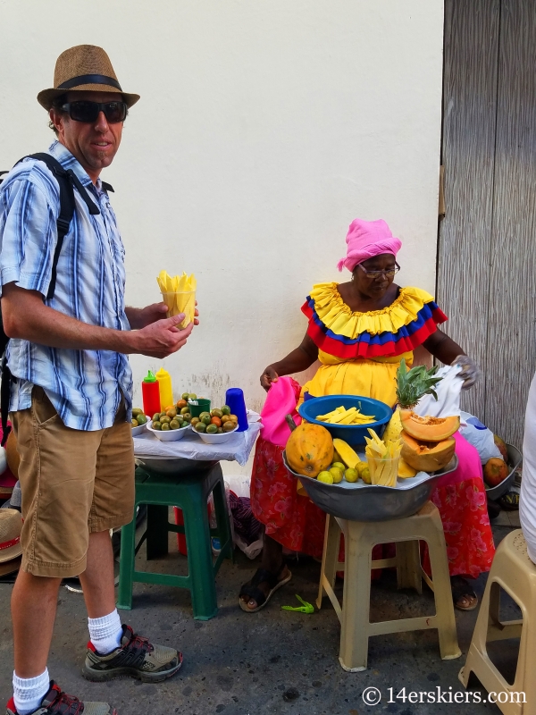 Enjoying papaya on the streets of colorful Cartagena.