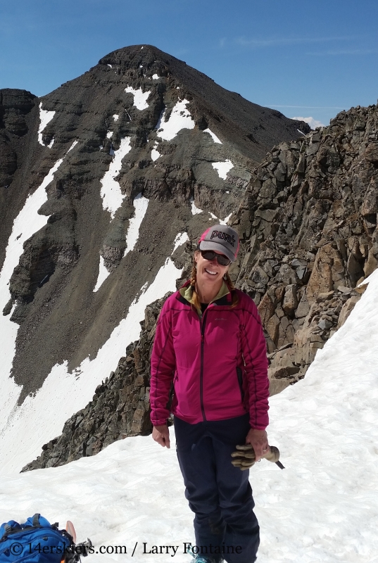 Brittany Konsella on top of Conundrum Couloir, with Castle Peak behind.