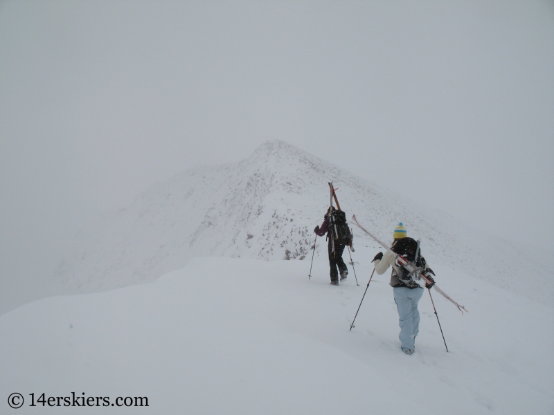 Climbing Culebra Peak to do backcountry skiing.