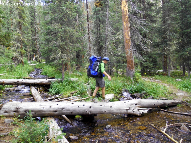 Frank crossing Lamphier Creek with a log