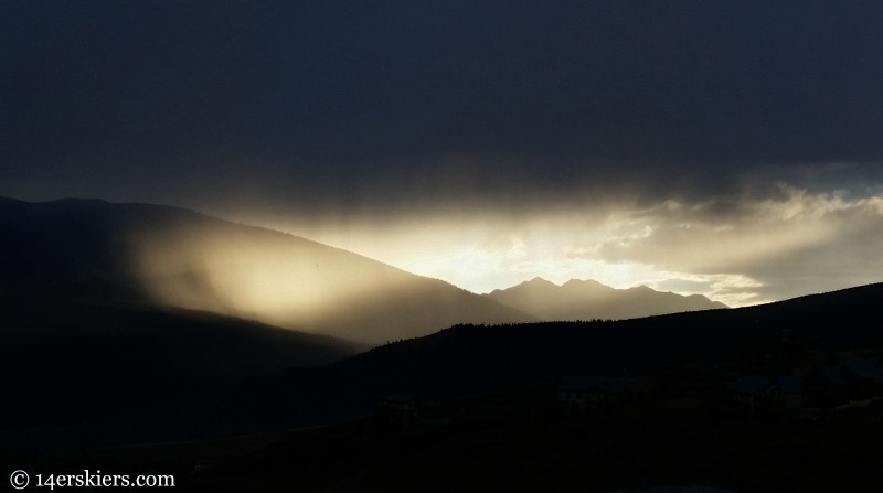 Light bursts through the clouds on a stormy evening in Crested Butte.