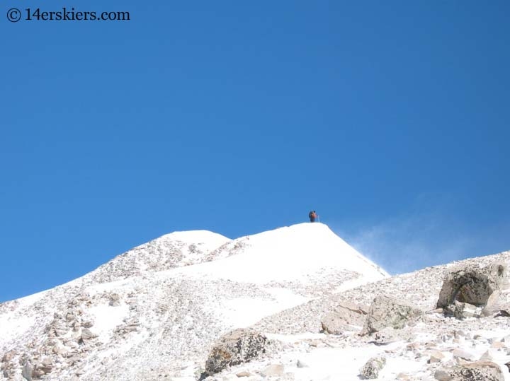 Frank Konsella climbing to go backcountry skiing on Mount Sherman.