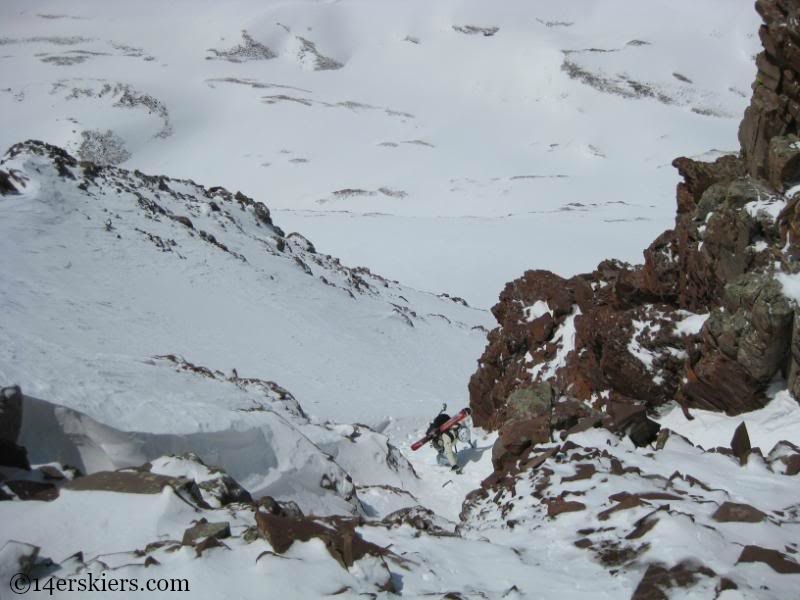 Climbing rock section to ski North Maroon.