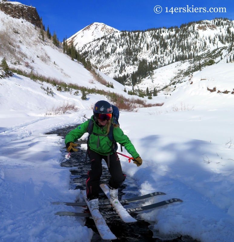 crossing a stream while backcountry skiing in Crested Butte