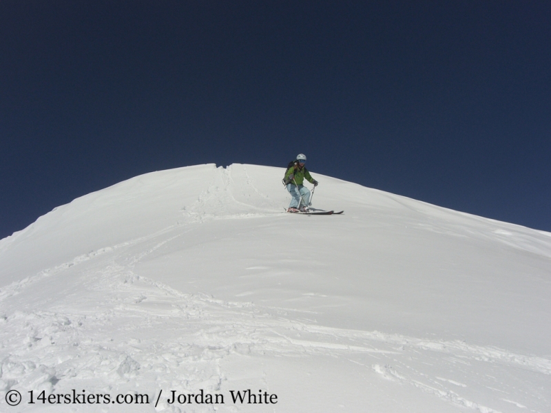 Brittany Walker Konsella backcountry skiing on Sunshine Peak. 