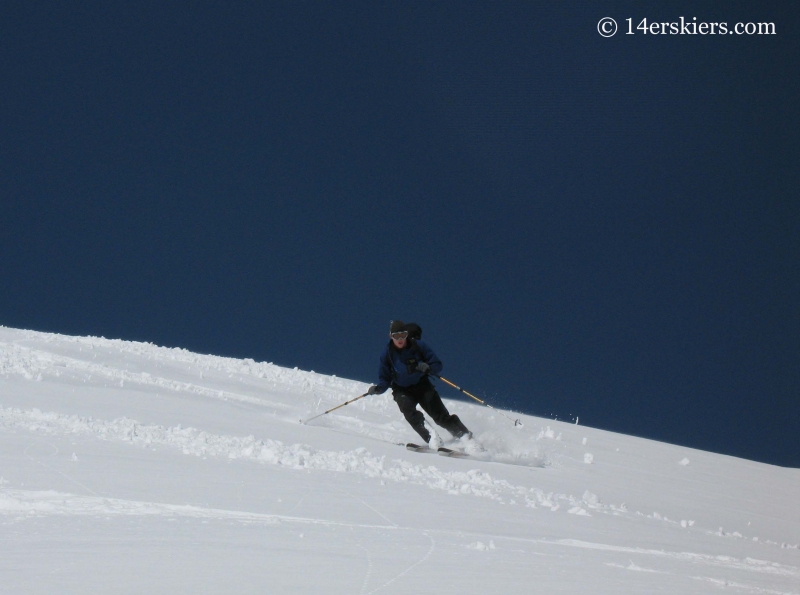 Jordan White backcountry skiing on Sunshine Peak. 