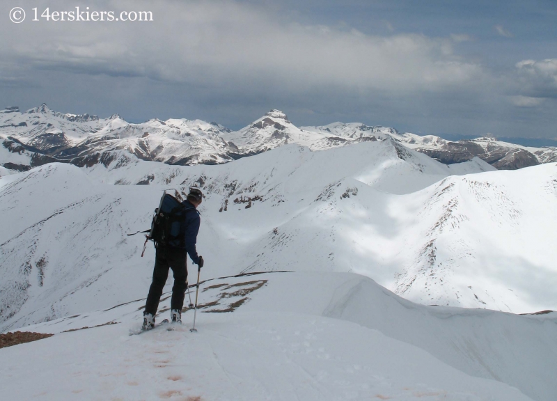 Jordan White skiing off summit of Redcloud Peak. 