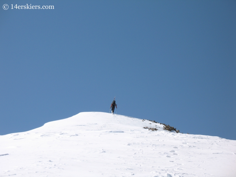 Jordan White summiting Sunshine Peak.