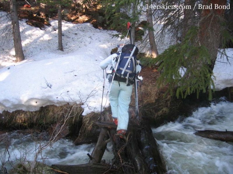 Brittany Walker Konsella crossing a bridge to go backcountry skiing on Tabeguache. 