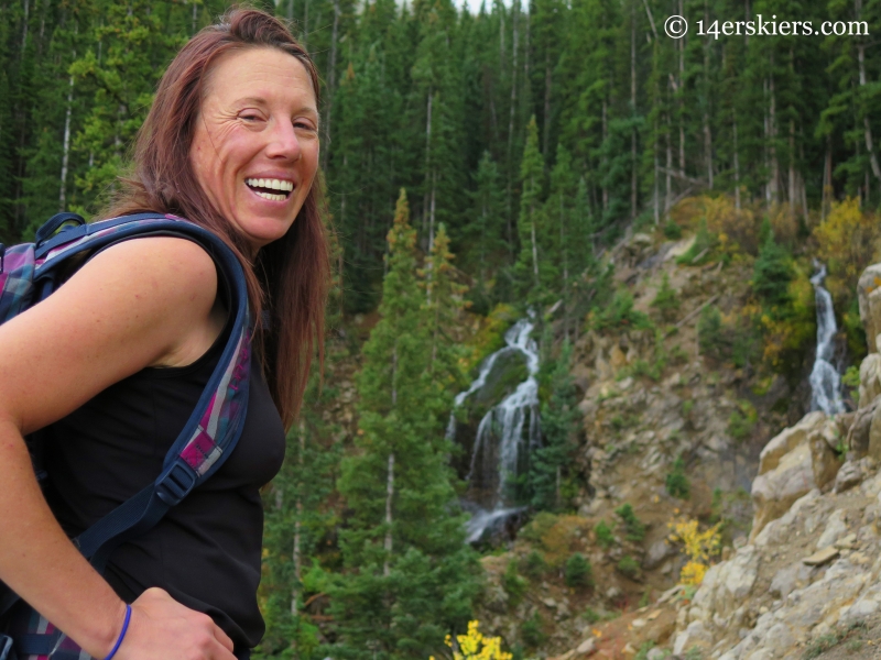 Susan Mol with waterfall near Three Lakes Trail