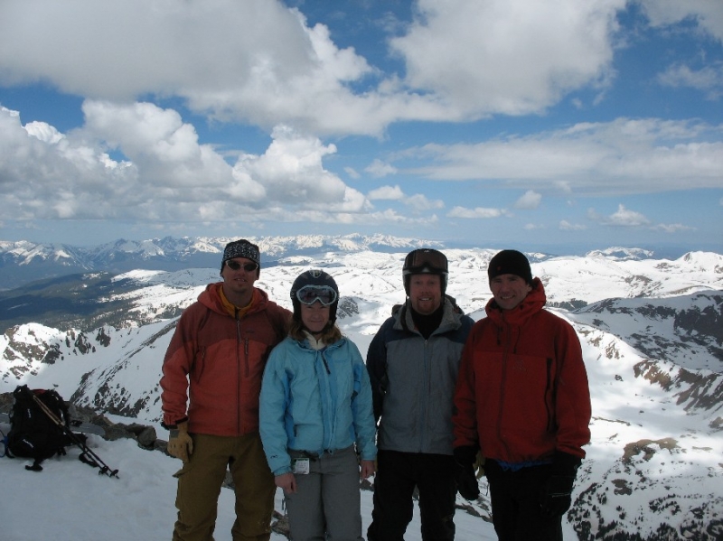 Four skiers on top of Torryes Peak while backcountry skiing in Colorado