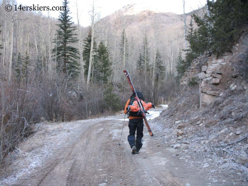 Frank Konsella hiking Nellie Creek Road to ski Uncompahgre