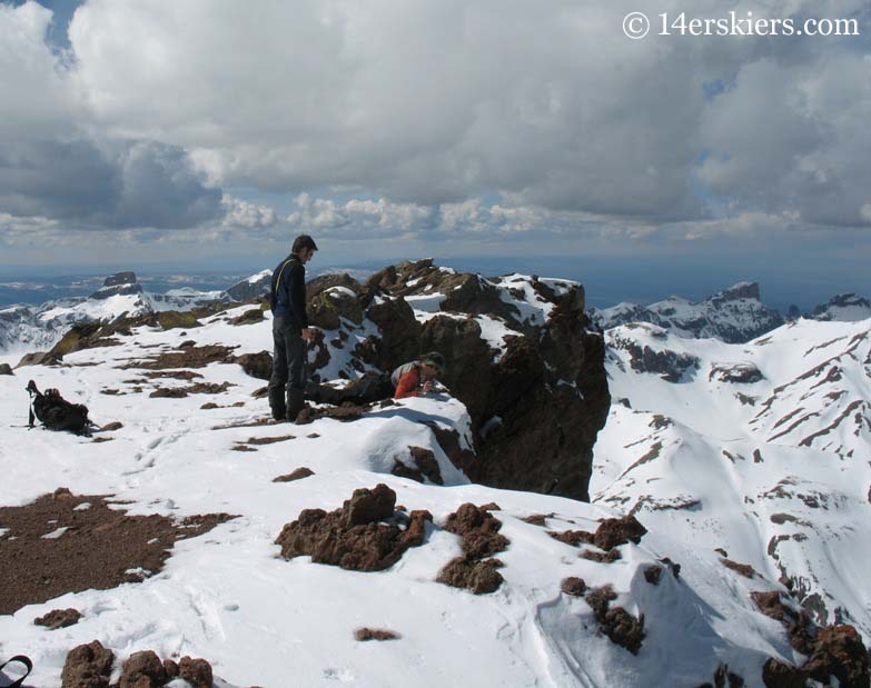 Frank looking over cliff on Uncompahgre Peak.