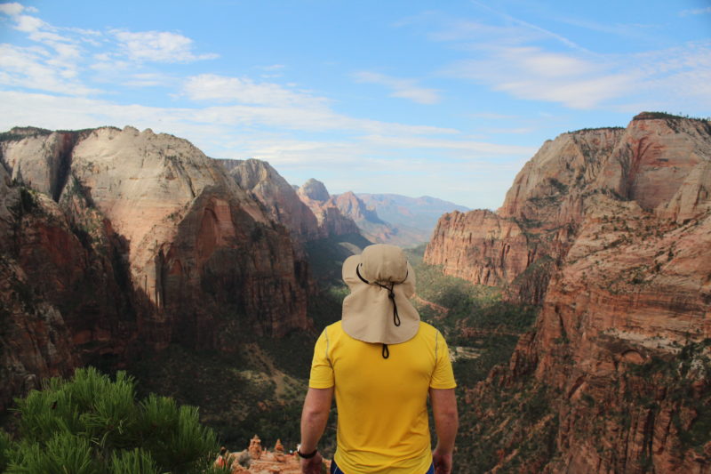 A hiker soaks in the views at Zion National Park.